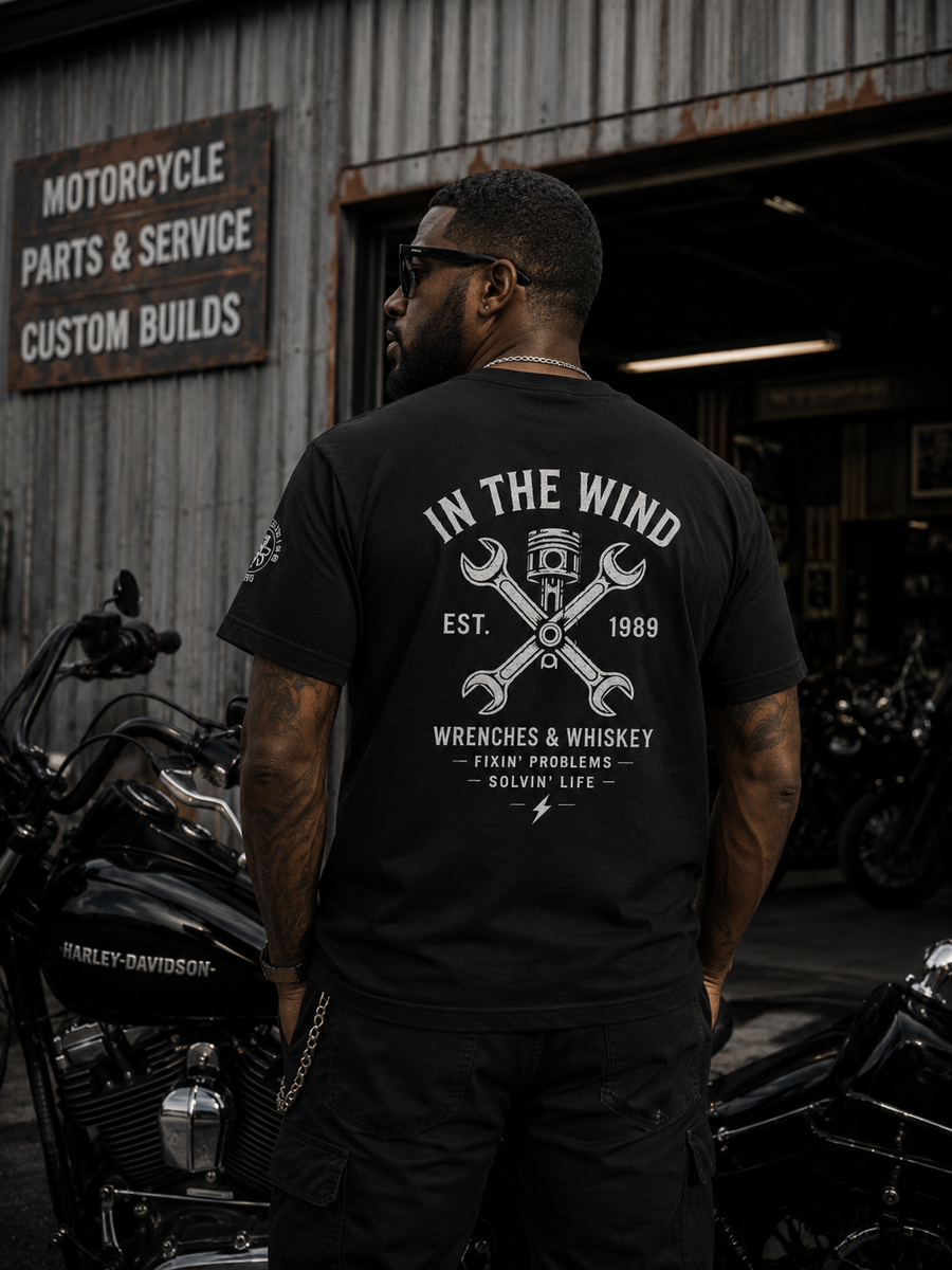 In The Wind™ Wrenches & Whiskey Graphic T-Shirt – Vintage Black.                                               4 Color Options